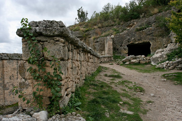 The cave and the wall in the medieval cave city Chufut-Kale near Bakhchisarai, Crimea.