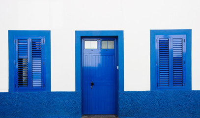 House with blue door and windows in Puerto de Mogan, Gran Canaria (Spain)