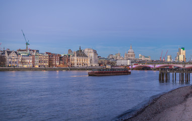 dusk on river Thames with London skyline