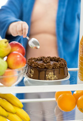 Big attractive chocolate cake in refrigerator is challenge for m