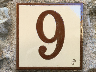 Ceramic tile with numer nine 9