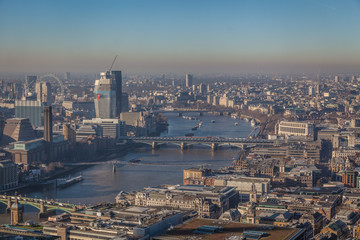 a view of river Thames in London on a sunny day with visible smog, air pollution