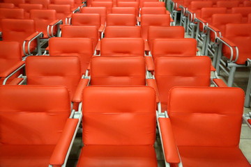 Armchairs with metal frame and red leather upholstery in a row