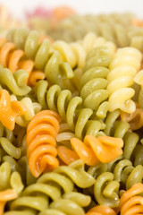 Closeup macro cooked colored macaroni background