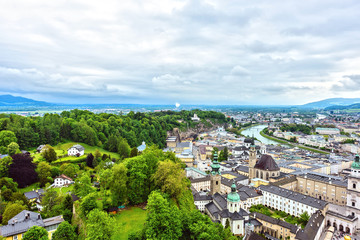 Fototapeta premium Salzburg city from the Hohensalzburg fortress. Green edge between the Historic center and nature, Austria