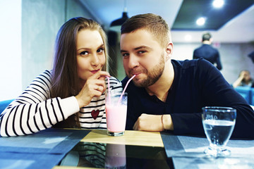 Two people in cafe enjoying the time spending with each other. Toned. Selective focus.
