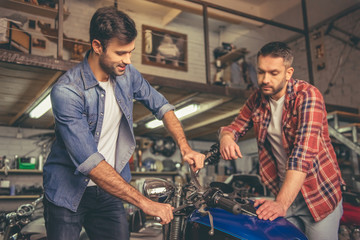 Fototapeta na wymiar Guys at the motorbike repair shop