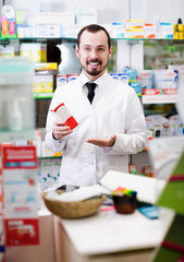 Smiling man medicine offer showing right drug
