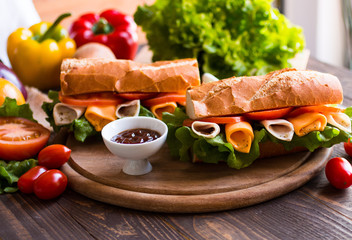 Delicious and Tasty sandwiches with turkey, ham, cheese, tomatoe
