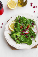 Healthy salad with baby spinach, pomegranate and rucola seasoned