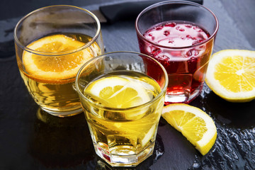 Cocktails glasses with lemon, orange and pomegranate