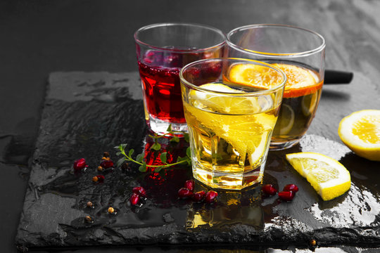 Cocktails glasses with lemon, orange and pomegranate