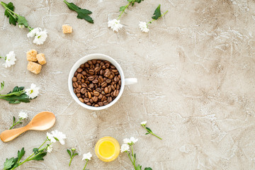 coffee beans on gray with coffe cup table top view