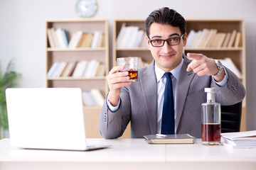 Young businessman drinking from stress