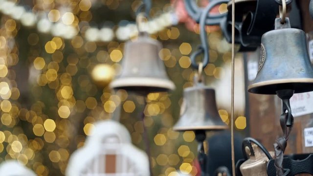 Closeup view of many beautiful old fashioned golden christmas bells hanging as new year
