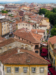 Fototapeta na wymiar Red shingled rooftops on curving streets of Pisa Italy.