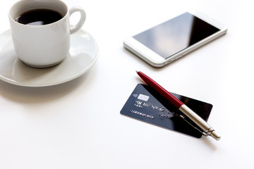 Fototapeta na wymiar credit card, keyboard, smartphone and coffee cup on white background