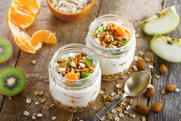 Healthy meal made of granola, yogurt and fruits. Delicious food for breakfast. Traditional American snack. Top view.