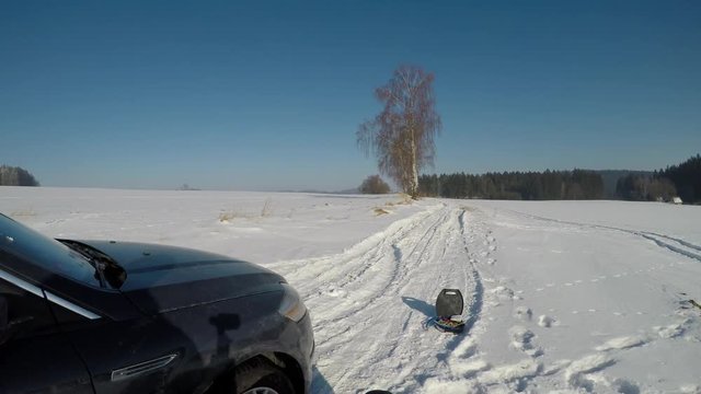 A man fitting snow chains.
The man put snow chains on the wrong road open to traffic. Sample fitting snow chains on your car.