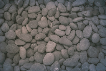 Fototapeta na wymiar Grey, blue, gold wee pebbles background, South Miami Beach, Florida, USA