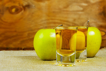 Two cider glasses  and green apples