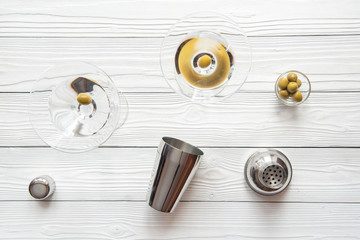 martini and shaker top view of wooden background