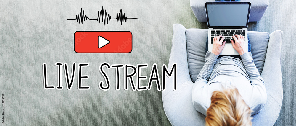 Wall mural live stream text with man using a laptop