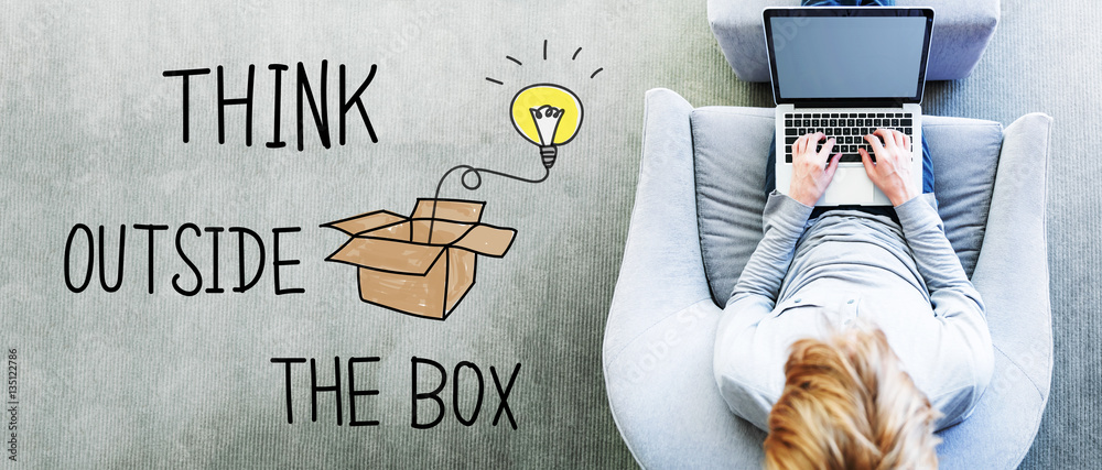 Wall mural think outside the box text with man using a laptop