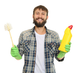 Young man with cleaning supplies on white background