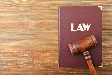 Judge gavel and Law book on wooden background