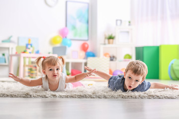 Obraz na płótnie Canvas Cute funny children playing on carpet at home