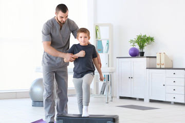 Physiotherapist working with patient in clinic