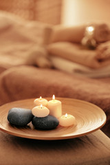 Obraz na płótnie Canvas Spa set with candles and stones on tray