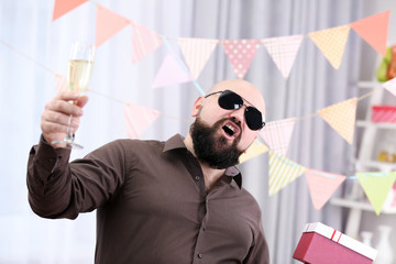 Funny fat man celebrating birthday at home