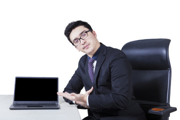 Businessman displaying a laptop on the table