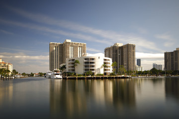 Fototapeta na wymiar Long exposure image of luxury condos and yachts at Aventura FL, USA
