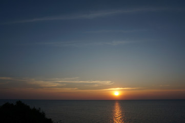 Naklejka na ściany i meble sunset on the sea, almost night by the sea,