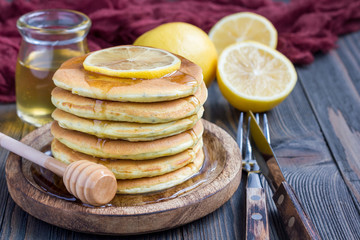 Healthy homemade lemon and chia seed pancakes served with honey, horizontal, copy space