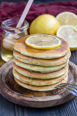 Healthy homemade lemon and chia seed pancakes served with honey, vertical