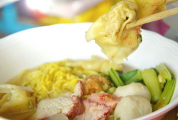 pork dumpling picking in wooden chopstick