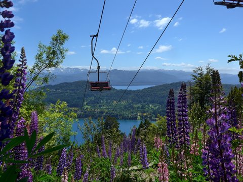 Fototapeta An empty Chairlift on Cerro Campanario in Bariloche in Spring with wild flowers blooming.