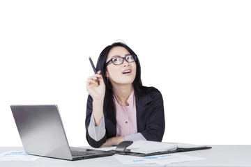 Thoughtful businessman with laptop and paperwork