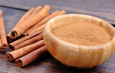Cinnamon powder in a bowl on table