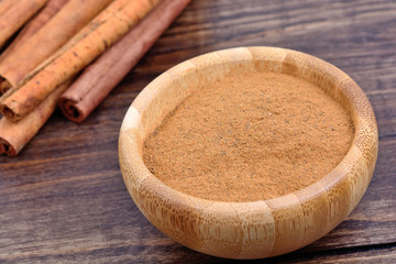 Bowl with cinnamon on table
