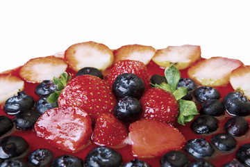 Yummy cake topped with fresh berries on studio
