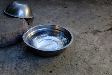 Stainless steel bowl with gray cement background
