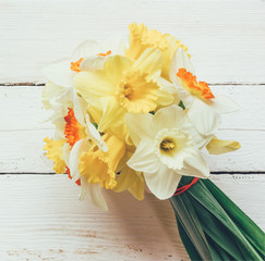 a bouquet of fresh flowers Narcissus on white wooden background