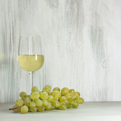 Grapes and glass of white wine with copyspace