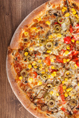 Vegetarian pizza on rustic wooden background, fast food