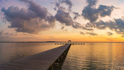 wooden pier overlooking the lake, the beautiful evening sky
